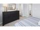 This is a bedroom with a large dark dresser and artwork at 290 Grand Silo Rd, Raleigh, NC 27603