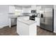 Stylish kitchen featuring white cabinets, stainless steel appliances, and a center island at 290 Grand Silo Rd, Raleigh, NC 27603