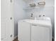 Functional laundry room featuring a washer and dryer with shelving above at 290 Grand Silo Rd, Raleigh, NC 27603