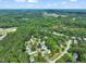 Neighborhood aerial view, showing houses surrounded by trees and landscaping, with a pond nearby at 2925 Dargan Hills Dr, Wake Forest, NC 27587