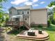 Expansive backyard with a deck, patio, and lush landscaping creates an ideal outdoor living space at 2925 Dargan Hills Dr, Wake Forest, NC 27587