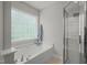 Bathroom featuring a soaking tub and separate glass-enclosed shower at 2925 Dargan Hills Dr, Wake Forest, NC 27587