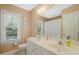 Classic bathroom features dual sinks, a large mirror, and a bright window at 2925 Dargan Hills Dr, Wake Forest, NC 27587