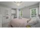 Bedroom with plush carpet, ceiling fan, and a built-in desk area with cabinets at 2925 Dargan Hills Dr, Wake Forest, NC 27587