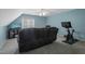 Bonus room featuring a wall-mounted TV, exercise bike, and a reclining sofa at 2925 Dargan Hills Dr, Wake Forest, NC 27587