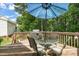 Outdoor deck with dining set and grill, perfect for entertaining in a private, wooded setting at 2925 Dargan Hills Dr, Wake Forest, NC 27587
