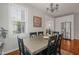 Dining room with a large window providing natural light, a wooden table, and view into kitchen at 2925 Dargan Hills Dr, Wake Forest, NC 27587