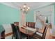 Dining room features a wooden table, chandelier, and hardwood floors leading to the stairway at 2925 Dargan Hills Dr, Wake Forest, NC 27587