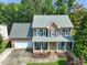 Beautiful two-story brick home with a welcoming front porch and well-manicured lawn at 2925 Dargan Hills Dr, Wake Forest, NC 27587