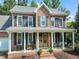 Charming brick home featuring a classic front porch with rocking chairs and a meticulously landscaped yard at 2925 Dargan Hills Dr, Wake Forest, NC 27587