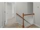 Hallway with carpeted stairs and wood railing leading to the upper level at 2925 Dargan Hills Dr, Wake Forest, NC 27587