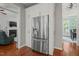 Butler's pantry area with white cabinets, stainless steel refrigerator, and hardwood floors at 2925 Dargan Hills Dr, Wake Forest, NC 27587