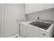 Laundry room with a washer, dryer, and overhead storage cabinets at 2925 Dargan Hills Dr, Wake Forest, NC 27587