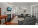 Cozy living room with a fireplace, dark gray sofa, and large windows for natural light at 2925 Dargan Hills Dr, Wake Forest, NC 27587