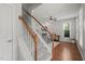 Elegant staircase with carpeted steps, white risers, and hardwood floors leading to living area at 2925 Dargan Hills Dr, Wake Forest, NC 27587