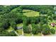 Establishing aerial view showing the property with mature trees on a large lot near a treed expanse at 296 Gordon Farm Dr, Benson, NC 27504