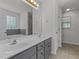Bright bathroom featuring double vanity sinks with gray cabinets at 296 Gordon Farm Dr, Benson, NC 27504