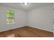 Bedroom featuring hardwood floors and a large window at 296 Gordon Farm Dr, Benson, NC 27504