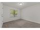 Cozy bedroom with neutral carpet, a large window, and ample natural light at 296 Gordon Farm Dr, Benson, NC 27504