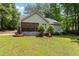 Exterior view of the back of the home featuring a screened porch and manicured lawn at 296 Gordon Farm Dr, Benson, NC 27504