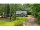 Well-maintained single-story home surrounded by lush greenery and mature trees, offering privacy and tranquility at 296 Gordon Farm Dr, Benson, NC 27504