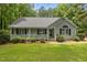 Charming single-story home featuring a welcoming front porch and beautifully landscaped front yard at 296 Gordon Farm Dr, Benson, NC 27504