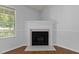 Cozy fireplace with decorative trim and marble hearth adds warmth and style to the bright living area at 296 Gordon Farm Dr, Benson, NC 27504