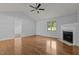 Hardwood floors and a fireplace add warmth to this living room with many windows and doors at 296 Gordon Farm Dr, Benson, NC 27504
