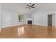 Spacious living room featuring hardwood floors, fireplace, ceiling fan, and natural light at 296 Gordon Farm Dr, Benson, NC 27504