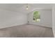 Spacious main bedroom featuring a vaulted ceiling, a ceiling fan, and a large arched window at 296 Gordon Farm Dr, Benson, NC 27504