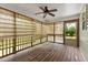 Relaxing screened porch with wooden floors and a ceiling fan at 296 Gordon Farm Dr, Benson, NC 27504