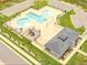 Aerial view of community pool, clubhouse, playground, and ample parking, perfect for relaxation and recreation at 301 Porter Hill Dr, Youngsville, NC 27596