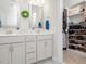 Bathroom featuring double vanity sinks, a walk-in shower, and a custom closet at 301 Porter Hill Dr, Youngsville, NC 27596