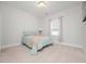 Cozy bedroom with a plush carpet, a comfortable bed, soft lighting, and a serene ambiance at 301 Porter Hill Dr, Youngsville, NC 27596