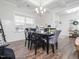 Dining room with coffered ceiling, modern chandelier and shiplap accent wall at 301 Porter Hill Dr, Youngsville, NC 27596
