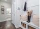 Inviting entryway featuring a bench, coat rack, and access to a stylishly decorated bathroom with a walk-in shower at 301 Porter Hill Dr, Youngsville, NC 27596