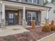 Inviting front porch with stone pillars, rocking chairs, and manicured landscaping at 301 Porter Hill Dr, Youngsville, NC 27596
