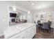 Modern kitchen showcasing granite countertops, a breakfast bar, and a seamless transition to the adjacent living room at 301 Porter Hill Dr, Youngsville, NC 27596