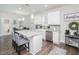 Eat-in kitchen with stainless steel appliances, granite countertops, white cabinets, and stylish island with bar seating at 301 Porter Hill Dr, Youngsville, NC 27596
