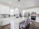 Bright kitchen features white cabinets, granite countertops, stainless steel appliances, and a stylish island with bar seating at 301 Porter Hill Dr, Youngsville, NC 27596