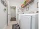 Bright laundry room with modern appliances, decorative elements, and access to an adjacent space for convenience at 301 Porter Hill Dr, Youngsville, NC 27596