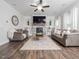 Bright living room with fireplace, built-in bookshelves, and hardwood floors at 301 Porter Hill Dr, Youngsville, NC 27596