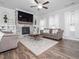 Cozy living room with fireplace, built-in bookshelves, and hardwood floors at 301 Porter Hill Dr, Youngsville, NC 27596