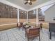 Relaxing screened porch with comfortable seating and patterned flooring, offering an ideal space for outdoor enjoyment at 301 Porter Hill Dr, Youngsville, NC 27596