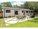 Backyard with a modern patio design, featuring geometric concrete slabs with grassy inlays and outdoor seating at 3032 Dixon Rd, Durham, NC 27707