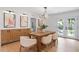 Dining room with hardwood floors, stylish lighting, and sliding glass doors to the back patio at 3032 Dixon Rd, Durham, NC 27707