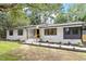 Beautifully renovated single-story home with painted white brick and professionally landscaped front yard at 3032 Dixon Rd, Durham, NC 27707