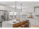 Modern kitchen with stainless steel appliances, marble countertops, and a large center island at 3032 Dixon Rd, Durham, NC 27707
