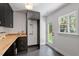 Mudroom with black cabinetry, butcher block countertops, black tile floors, and an exterior entrance at 3032 Dixon Rd, Durham, NC 27707