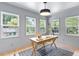 Bright, naturally lit office with three large windows and a simple wood desk with modern lighting at 3032 Dixon Rd, Durham, NC 27707